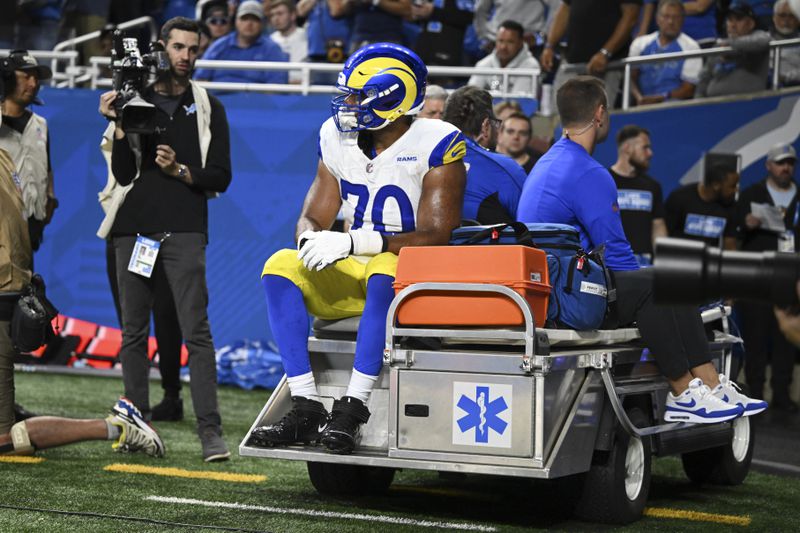 Los Angeles Rams offensive tackle Joe Noteboom (70) rides a cart to the locker room after being injured against the Detroit Lions during the first half of an NFL football game in Detroit, Sunday, Sept. 8, 2024. (AP Photo/David Dermer)