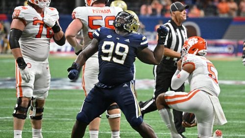 Georgia Tech defensive lineman D'Quan Douse (99) reacts after taking down Clemson's quarterback DJ Uiagalelei (5) during the first half of Chick-fil-A Kickoff game at Mercedes-Benz Stadium in Atlanta on Monday, Sept. 5, 2022. (Hyosub Shin / Hyosub.Shin@ajc.com)