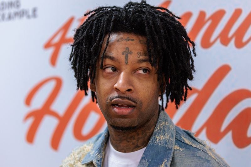 Rapper 21 Savage gave out gifts to families at the Wade Walker Park Family YMCA in Stone Mountain on Wednesday, December 21, 2022. Dec. 21 was pronounced “21 Savage Day” in the state for the rapper’s philanthropic efforts. (Arvin Temkar / arvin.temkar@ajc.com)