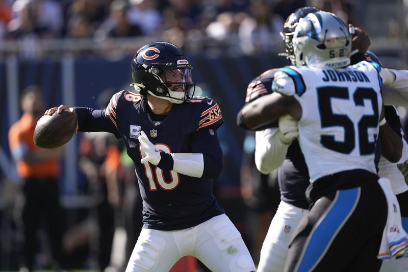 Chicago Bears quarterback Caleb Williams (18) throws against the Carolina Panthers during the second half of an NFL football game Sunday, Oct. 6, 2024, in Chicago. (AP Photo/Charles Rex Arbogast)