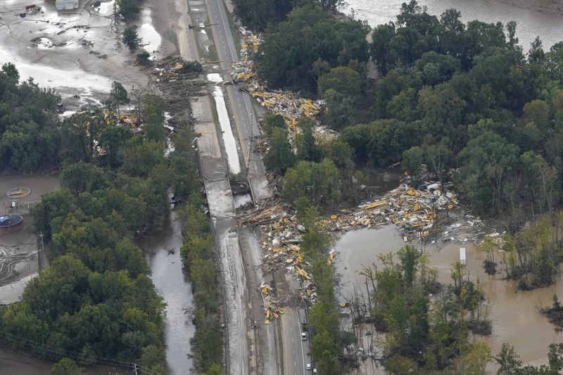 An aerial view of flood damage in the aftermath of Hurricane Helene, Saturday, Sept. 28, 2024, in Erwin, Tenn. (AP Photo/George Walker IV)