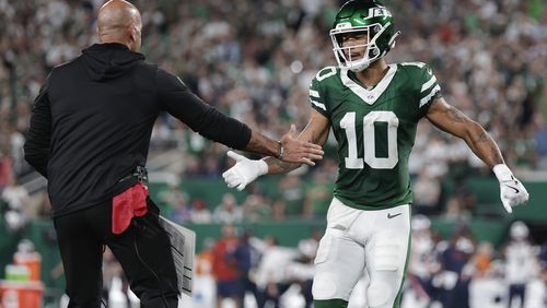 New York Jets wide receiver Allen Lazard (10) is congratulated by New York Jets head coach Robert Saleh after Lazard scored a touchdown against the New England Patriots during the first quarter of an NFL football game, Thursday, Sept. 19, 2024, in East Rutherford, N.J. (AP Photo/Adam Hunger)