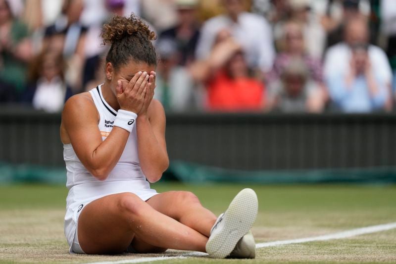 Jasmine Paolini of Italy reacts after she slipped over on court after attempting to play a return to Barbora Krejcikova of the Czech Republic during the women's singles final at the Wimbledon tennis championships in London, Saturday, July 13, 2024. (AP Photo/Mosa'ab Elshamy)