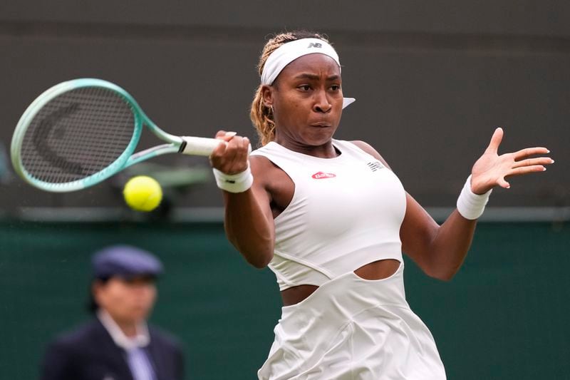 Coco Gauff of the United States plays a forehand return to Anca Todoni of Romania during their match on day three at the Wimbledon tennis championships in London, Wednesday, July 3, 2024. (AP Photo/Mosa'ab Elshamy)