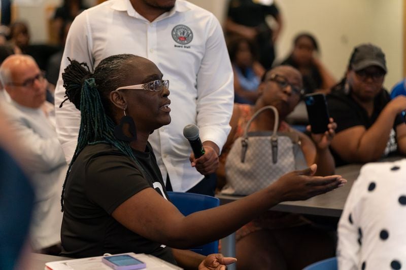 Shiqueta Swanson-Williams, a custodian at Carver New Schools, asks Bryan Johnson, the sole finalist for Atlanta Public Schools superintendent, a question at the Atlanta school on Tuesday, June 25, 2024. (Seeger Gray/AJC)