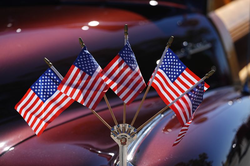 American flags splay out in a display attached to the fender crest of a 1948 Pontiac Silver Streak station wagon owned by Leo and Angi Martinez during the Colorado 4th at Firestone parade to mark the Independence Day holiday Thursday, July 4, 2024, in Firestone, Colo. Floats, marching bands, classic cars and motorcycles were features in the annual parade through the Weld County community north of Denver. (AP Photo/David Zalubowski)