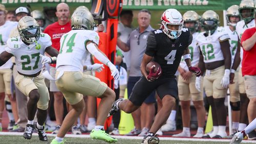 Milton wide receiver CJ Wiley (4) runs after a catch against Buford defenders during the first half against Buford at Milton High School, Friday, August 16, 2024, in Milton, Ga. (Jason Getz / AJC)
