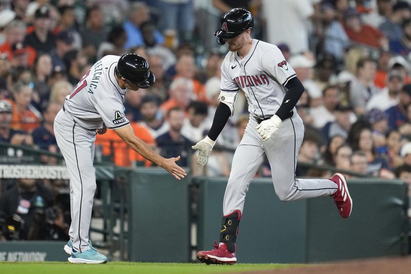 Arizona Diamondbacks' Pavin Smith, right, celebrates after his three-run home run against the Houston Astros with third base coach Tony Perezchica during the second inning of a baseball game Sunday, Sept. 8, 2024, in Houston. (AP Photo/Eric Christian Smith)