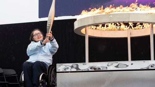 British Paralympian Helene Raynsford holds the Paralympic Torch during the flame lighting ceremony in Stoke Mandeville, widely considered the birthplace of the Paralympic Games, England, Saturday, Aug. 24, 2024. (AP Photo/Thomas Krych)