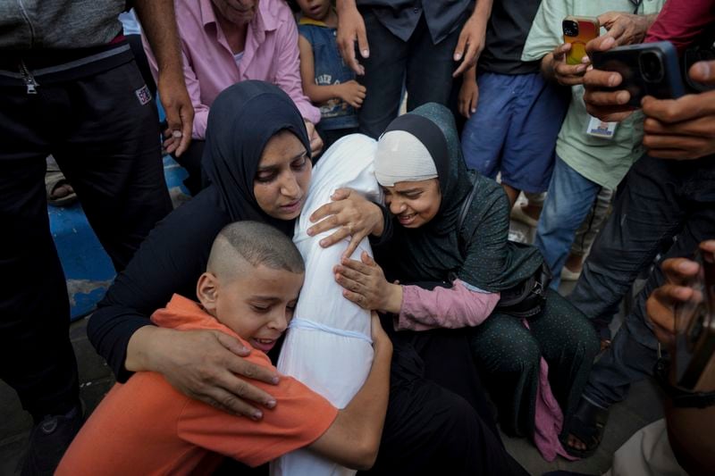 Palestinians mourn for their relative girl killed in an Israeli bombardment on a residential building owned by the Nasr family in the Maghazi refugee camp outside the morgue of al-Aqsa Martyrs Hospital in Deir al Balah, central Gaza Strip, Tuesday, June 25, 2024. (AP Photo/Abdel Kareem Hana)