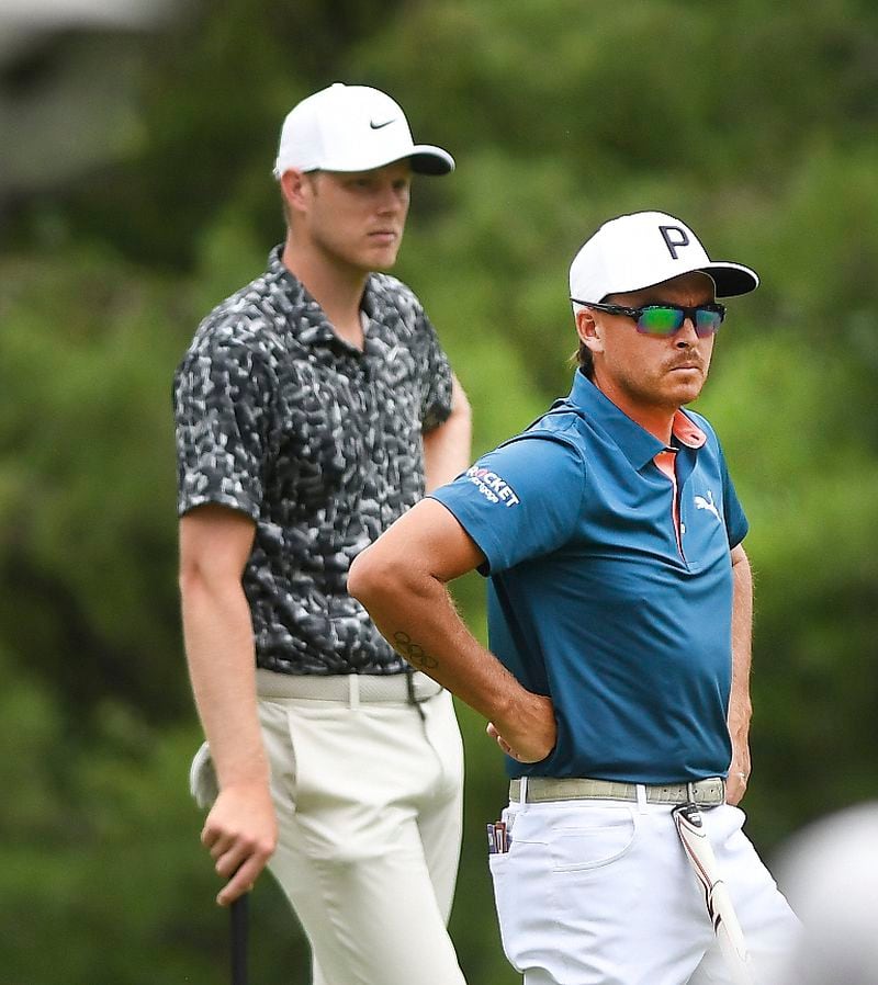 Cam Davis, left, and Rickie Fowler look over the eighth green during the second round of the Rocket Mortgage Classic golf tournament at the Detroit Golf Club in Detroit, Michigan, Friday, June 27, 2024. (Daniel Mears/Detroit News via AP)