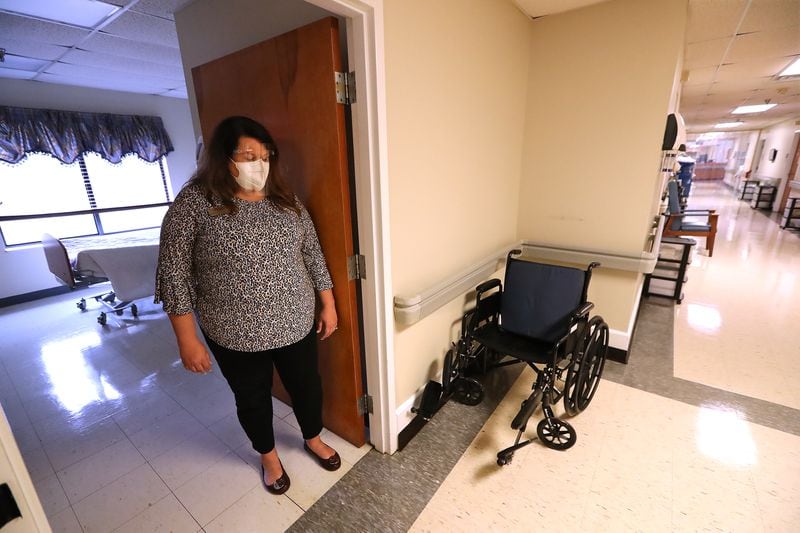Jennifer Vasil, a registered nurse and administrator, stands in the doorway of an empty room on the hallway where residents with COVID-19 were treated at Westbury Medical Care and Rehab in Jackson.  “Curtis Compton / Curtis.Compton@ajc.com”