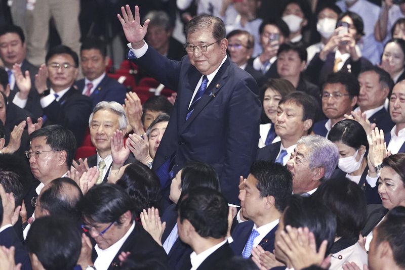 Shigeru Ishiba, center, waves as he is elected as leader of the ruling Liberal Democratic Party after the party's leadership election, in Tokyo Friday, Sept. 27, 2024. (Kyodo News via AP)