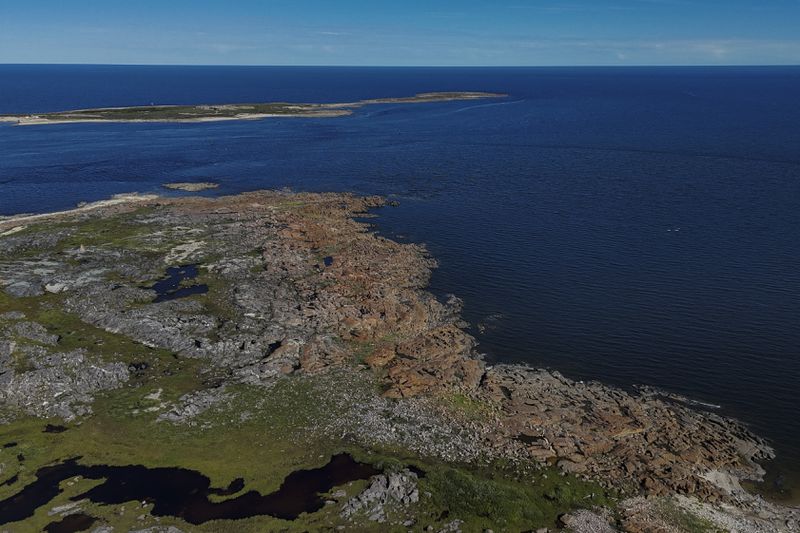 The Churchill River, left, empties into the Hudson Bay, right, Thursday, Aug. 8, 2024, near Churchill, Manitoba. (AP Photo/Joshua A. Bickel)