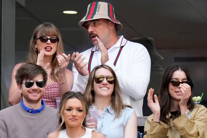 Taylor Swift, left, and Travis Kielce watch play between Jannik Sinner, of Italy, and Taylor Fritz, of the United States, during the men's singles final of the U.S. Open tennis championships, Sunday, Sept. 8, 2024, in New York. (AP Photo/Kirsty Wigglesworth)