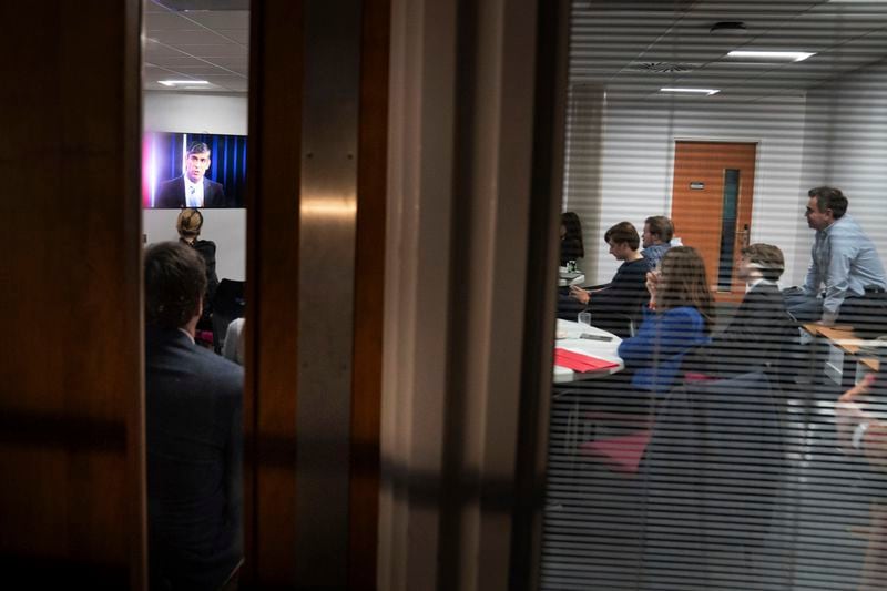 Britain's Prime Minister Rishi Sunak's advisors watch him take part in the BBC Question Time election special in York, England, from their green room, Thursday, June 20, 2024. (Stefan Rousseau/Pool Photo via AP)