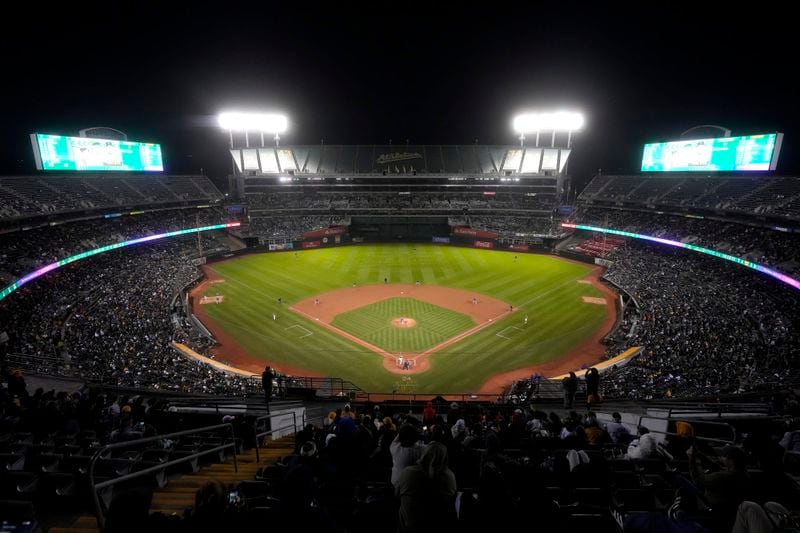 Fans at the Oakland Coliseum watch during the third inning of a baseball game between the Oakland Athletics and the Texas Rangers in Oakland, Calif., Wednesday, Sept. 25, 2024. (AP Photo/Jeff Chiu)