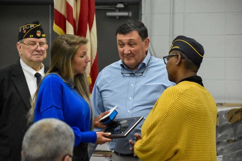 Trina Minix, in blue, receives the Officer of the Year on behalf of her late husband, Coweta County Deputy Eric Minix.