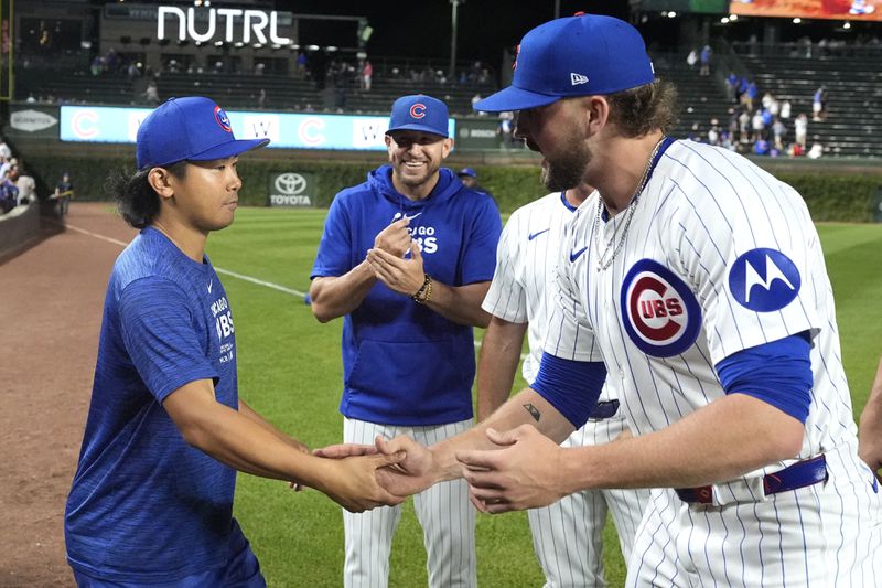 Chicago Cubs pitcher Shota Imanaga, left, and relief pitcher Porter Hodge shake hands as pitching coach Tommy Hottovy, center, smiles, after Imanaga, Hodge and Nate Pearson combined for a no-hitter against the Pittsburgh Pirates in the team's 12-0 win over the Pittsburgh Pirates in a baseball game Wednesday, Sept. 4, 2024, in Chicago. (AP Photo/Charles Rex Arbogast)