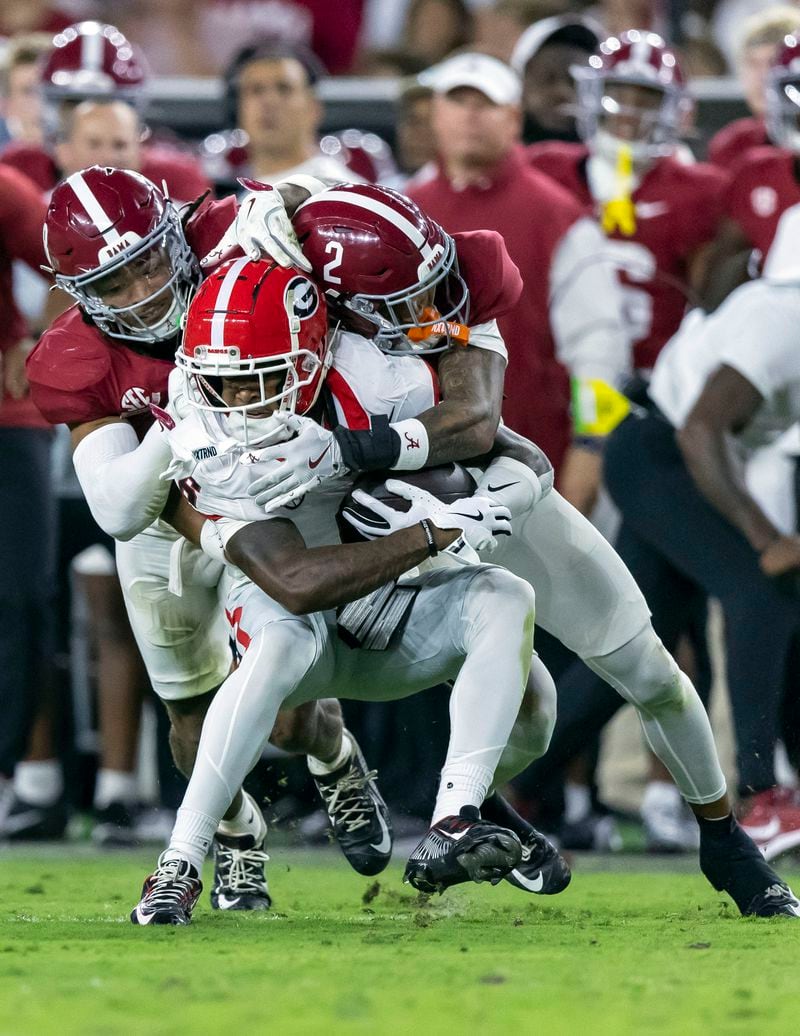 Alabama defensive backs DeVonta Smith, left, and Zabien Brown (2) tackle Georgia wide receiver Dominic Lovett (6) during the first half of an NCAA college football game, Saturday, Sept. 28, 2024, in Tuscaloosa, Ala. (AP Photo/Vasha Hunt)