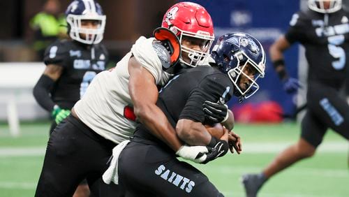 Savannah Christian defensive lineman Elijah Griffin (95) tackles Cedar Grove quarterback Elliott Colson (1) during the Class 3A GHSA State Championship game at Mercedes-Benz Stadium, Wednesday, December. 13, 2023, in Atlanta. (Jason Getz / Jason.Getz@ajc.com)