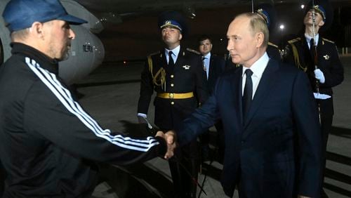 Russian President Vladimir Putin greets Vadim Krasikov upon arrival of freed Russian prisoners at Vnukovo government airport outside Moscow, Russia, Aug. 1, 2024. The United States and Russia have made their biggest prisoner swap in post-Soviet history. (Mikhail Voskresensky, Sputnik, Kremlin Pool Photo via AP)