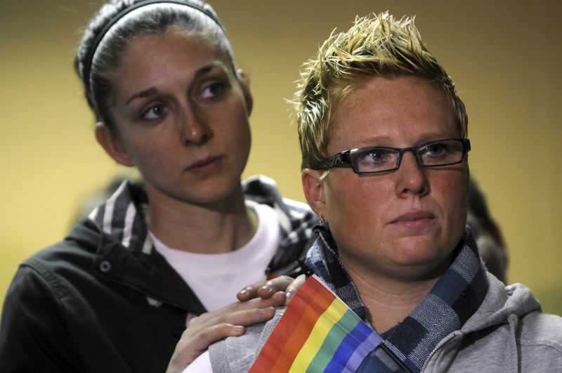 FILE - Heidi Buehler, right, and partner Jennifer Chesney listen to speakers, May 19, 2014, in Portland, Ore. (Stephanie Yao Long/The Oregonian via AP, File)