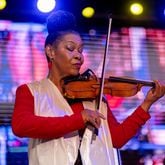 Violinist Karen Briggs performs Saturday at The Stockbridge Amphitheater. Briggs' Contempo Orchestra was the main attraction at a star-filled show that featured Oleta Adams, Phil Perry and Regina Belle. (Ben Hendren for the Atlanta Journal-Constitution)