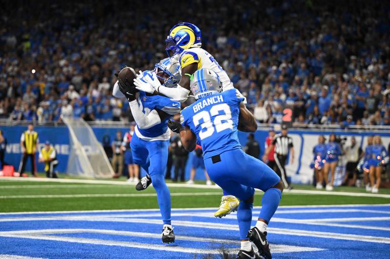 Detroit Lions safety Kerby Joseph (31) intercepts a pass intended for Los Angeles Rams wide receiver Tyler Johnson (18) in the end zone as Detroit Lions safety Brian Branch (32) looks on during the first half of an NFL football game in Detroit, Sunday, Sept. 8, 2024. (AP Photo/David Dermer)