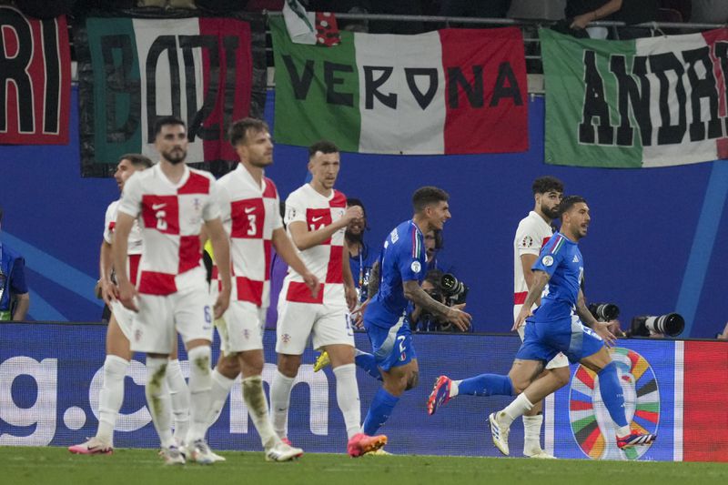 Italy's Mattia Zaccagni, right, celebrates after scoring his side's opening goal of Group B match between Croatia and Italy at the Euro 2024 soccer tournament in Leipzig, Germany, Monday, June 24, 2024. (AP Photo/Sunday Alamba)