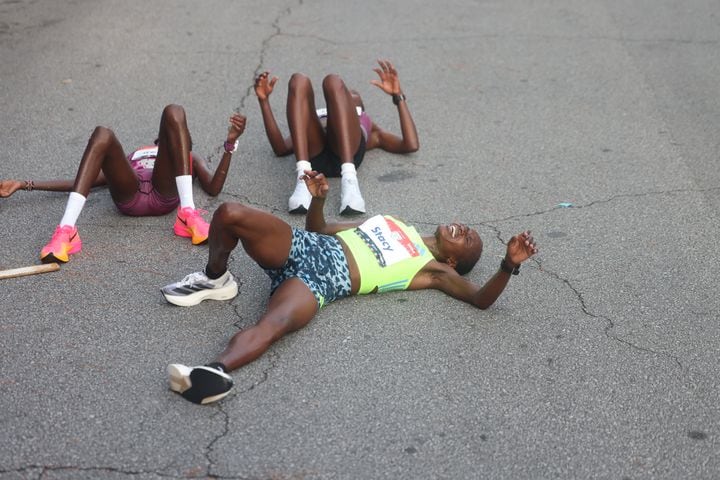 Elite women’s winner Stacy Ndiwa and others collapse at the end of the 55th running of the Atlanta Journal-Constitution Peachtree Road Race in Atlanta on Thursday, July 4, 2024.   (Jason Getz / AJC)