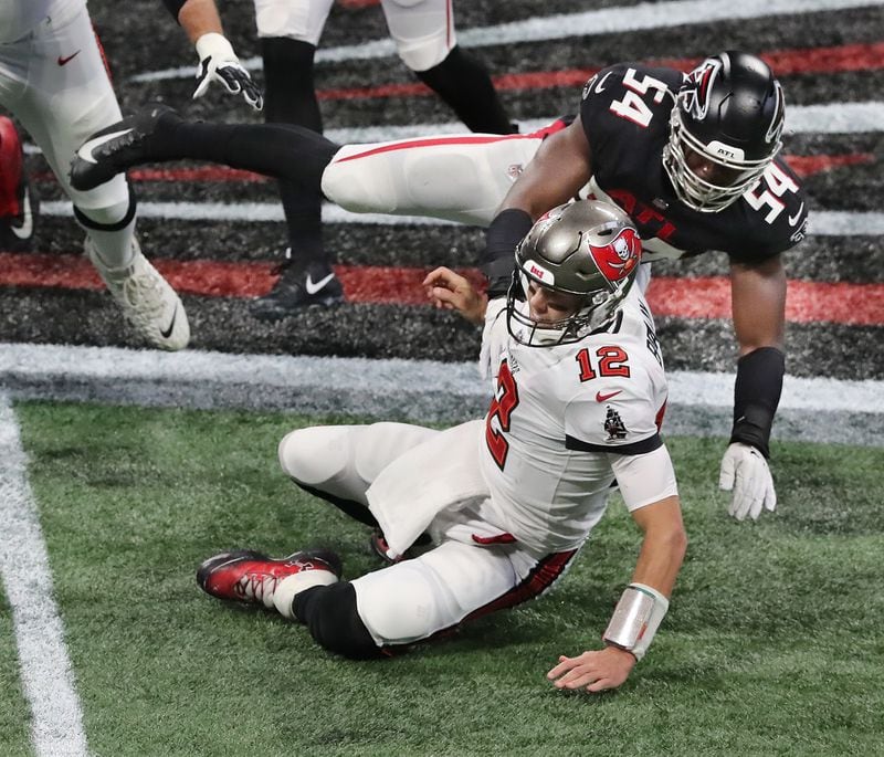 Falcons linebacker Foye Oluokun knocks Buccaneers Tom Brady to the turf during the second quarter Sunday, Dec. 20, 2020, at Mercedes-Benz Stadium in Atlanta. (Curtis Compton / Curtis.Compton@ajc.com)