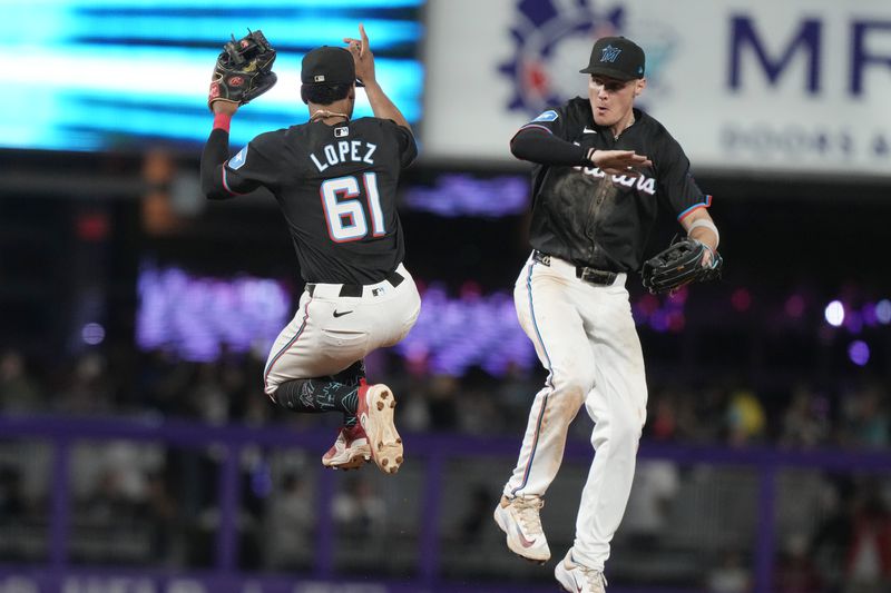 Miami Marlins second baseman Otto Lopez (61) and center fielder Kyle Stowers celebrate at the end of a baseball game against the Atlanta Braves, Friday, Sept. 20, 2024, in Miami. (AP Photo/Marta Lavandier)