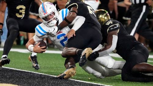 Mississippi quarterback Jaxson Dart (2) stretches in for a touchdown against Wake Forest defensive back Rushaun Tongue (6) during the second half of an NCAA college football game in Winston-Salem, N.C., Saturday, Sept. 14, 2024. (AP Photo/Chuck Burton)