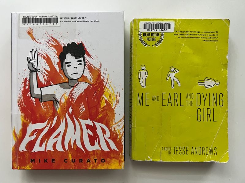 Two books - "Flamer" by Mike Curato and "Me and Earl and the Dying Girl" by Jesse Andrews - were removed from school libraries in Cobb County. The books in this photo were checked out from the Atlanta-Fulton Public Library.