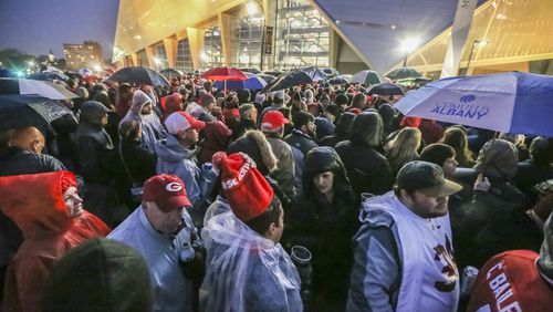 January 8, 2018 Atlanta: Crowds wait to get in the game in downtown Atlanta on Monday, Jan. 8, 2018. The Alabama Crimson Tide were 3.5-point favorites going into Monday night’s College Football Playoff Championship against the Georgia Bulldogs at Atlanta’s Mercedes-Benz Stadium. Gov. Nathan Deal ordered non-essential state offices from Columbus to Augusta and northward to close Monday, and city of Atlanta officials announced a similar order for local offices. Officials began announcing closures to ease traffic burdens early, in large part because of the game. The 8pm kick off for the championship, will see US President Donald Trump in attendance. Kendrick Lamar was scheduled to perform a free halftime concert at Centennial Olympic Park. JOHN SPINK/JSPINK@AJC.COM