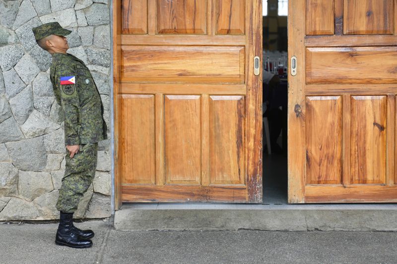 A cadet of the Philippine Military Academy stands at attention outside a hall at Fort Gregorio Del Pilar in Baguio, northern Philippines on Thursday, Aug. 29, 2024. (AP Photo/Aaron Favila)