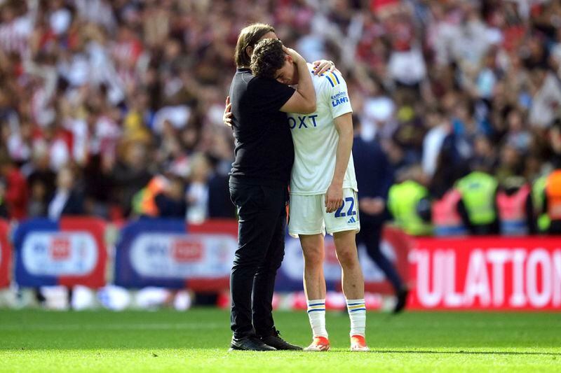 Leeds United manager Daniel Farke consoles Archie Gray after being defeated by Southampton in the Championship play-off final at Wembley Stadium, London, Sunday May 26, 2024. (Adam Davy/PA via AP)