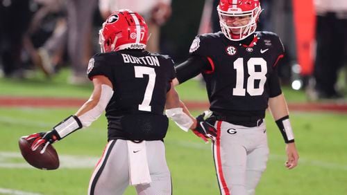 Bulldogs wide receiver Jermaine Burton (7) celebrates with Georgia Bulldogs quarterback JT Daniels (18) after scoring a TD near the end of the half against Mississippi State Bulldogs on Saturday, Nov. 21, 2020 at Sanford Stadium in Athens. (Curtis Compton / Curtis.Compton@ajc.com)