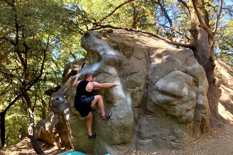 In this image provided by Shelby Schweitzer, New York Jets offensive lineman Wes Schweitzer climbs Castle Rock in Castle Rock State Park, Calif., in 2021. (Shelby Schweitzer via AP)