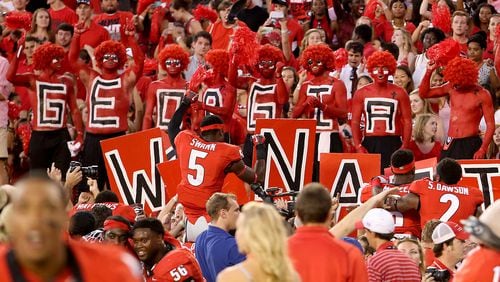 The huge crowds drawn to college football games on fall Saturdays in Athens and elsewhere across the South are a huge draw in their own right to candidates in an election year. JASON GETZ / JGETZ@AJC.COMto