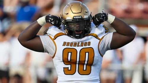 Douglass defensive lineman John Amofah celebrates after a tackle of a LaGrange ball carrier during the second half in the Corky Kell Dave Hunter Classic at Kell High School, Wednesday, August 14, 2024, in Marietta, Ga. Douglass won 18-3. (Jason Getz / AJC)
