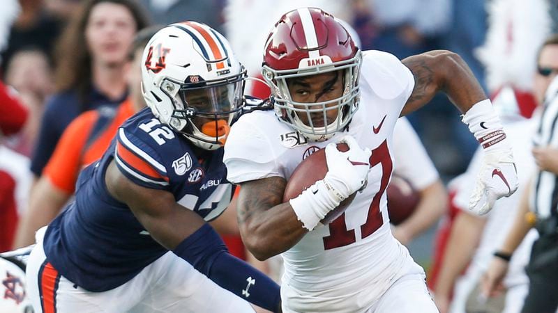 Alabama wide receiver Jaylen Waddle (17) carries the ball as he gets around Auburn wide receiver Eli Stove (12) on a punt return during the first half Saturday, Nov. 30, 2019, in Auburn, Ala. (Butch Dill/AP)