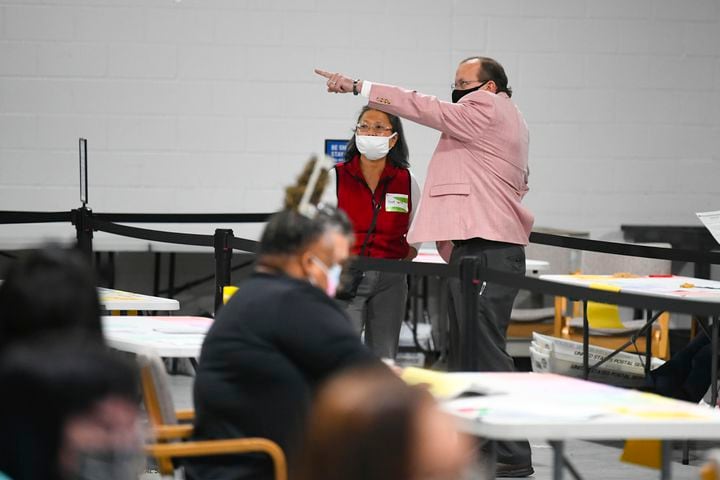 Observers look on as votes for President are recounted at the Gwinnett County elections office on Friday, Nov.13, 2020 in Lawrenceville. (JOHN AMIS FOR THE ATLANTA JOURNAL-CONSTITUTION)