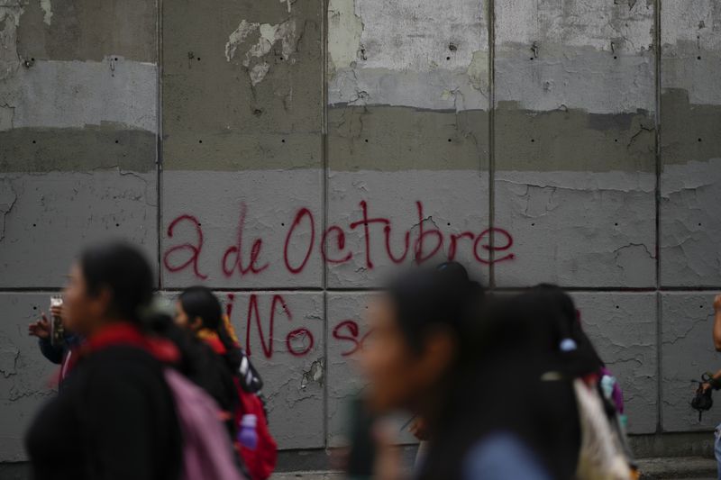 Demonstrators march to mark the 56th anniversary of the killing of student protesters at Tlatelolco plaza when soldiers opened fire on a peaceful demonstration, in Mexico City, Wednesday, Oct. 2. 2024. (AP Photo/Eduardo Verdugo)