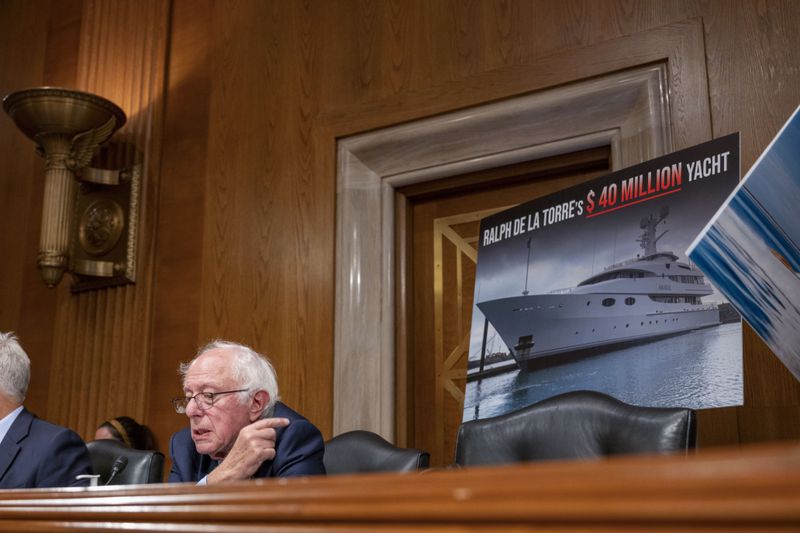 Sen. Bernie Sanders, I-Vt., points to a photo of a yacht owned by Steward Health Care System CEO Ralph de la Torre who failed to show and testify before the Senate Health, Education, Labor, and Pensions hearing to examine the bankruptcy of Steward Health Care on Thursday, Sept. 12, 2024 on Capitol Hill in Washington. (AP Photo/Kevin Wolf)