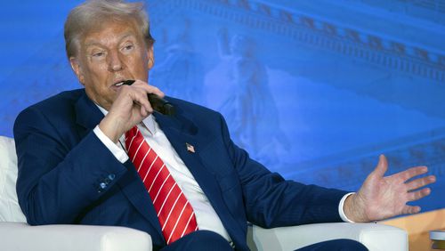 Republican presidential nominee former President Donald Trump speaks with Moms for Liberty co-founder Tiffany Justice during an event at the group's annual convention in Washington, Friday, Aug. 30, 2024. (AP Photo/Jose Luis Magana)