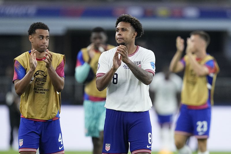 Weston McKennie of the United States and teammates celebrate their team's 2-0 victory over Bolivia at the end of a Copa America Group C soccer match in Arlington, Texas, Sunday, June 23, 2024. (AP Photo/Tony Gutierrez)