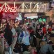 Fans cheer during a watch party at The Battery at Truist Park after Braves player Jorge Soler hits a home run in the first inning of the first game of the World Series between the Braves and Astros being held Tuesday, Oct. 26, 2021, in Houston. (Photo: Branden Camp for The Atlanta Journal-Constitution)