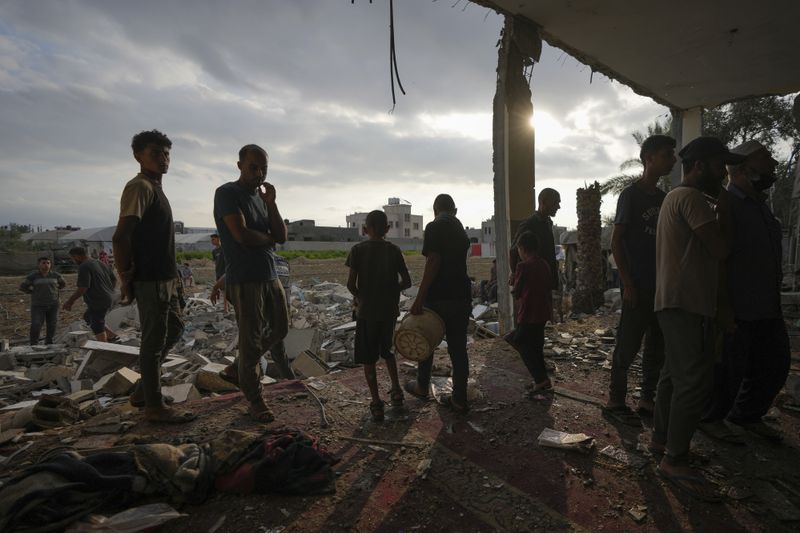 Palestinians examine a destroyed mosque following an Israeli airstrike in Deir al-Balah, Sunday, Oct. 6, 2024. (AP Photo/Abdel Kareem Hana)